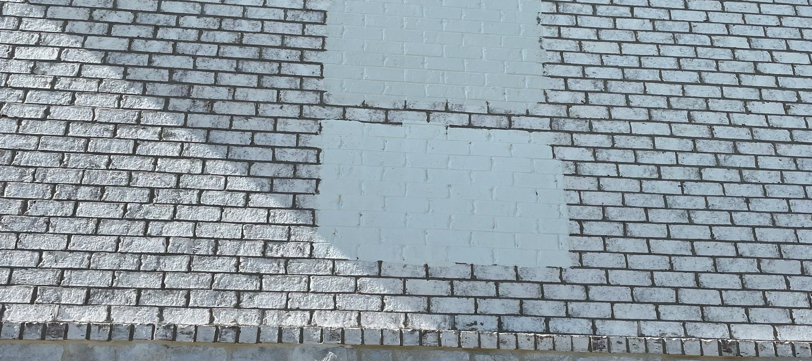 Exterior brick painted white with a paint color match sample